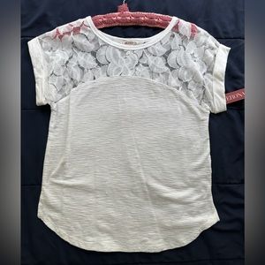 White top with lace detail across shoulders.